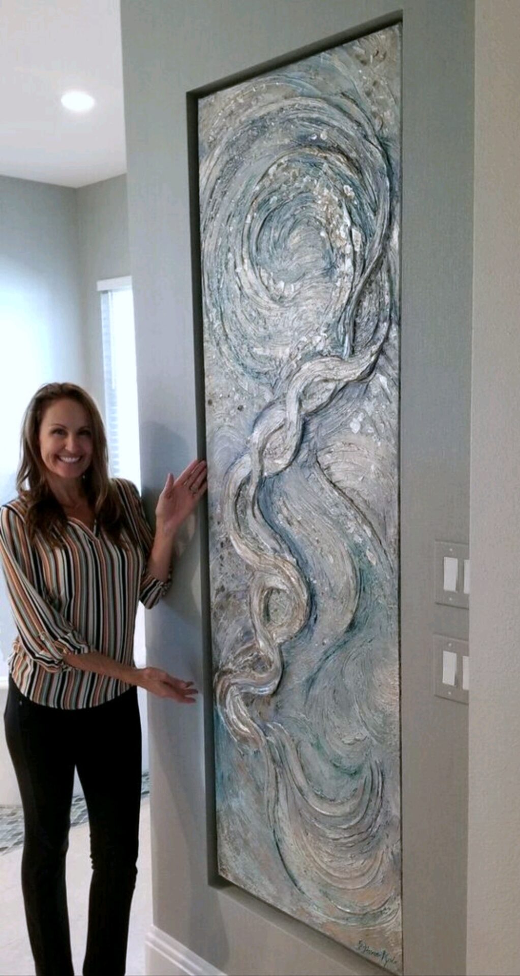 Diane Kole showcasing her beautiful wall carving made of crystals