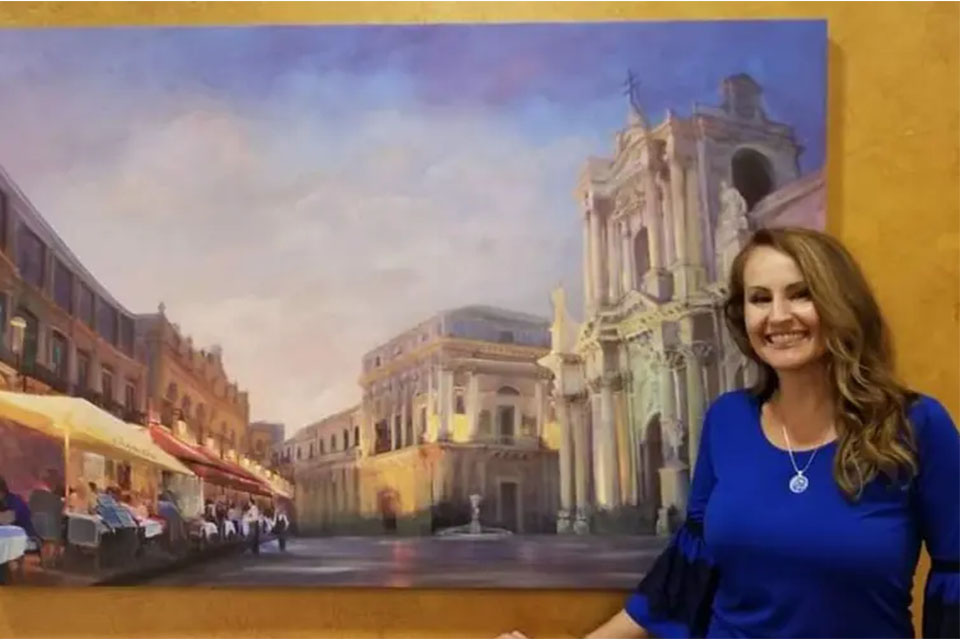 Woman Standing Infront Of A Beautiful Painting