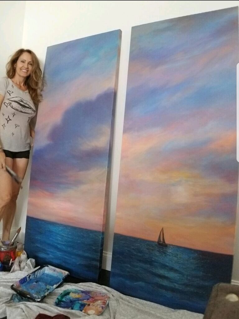 Diane Kole painting a boat in the the sea